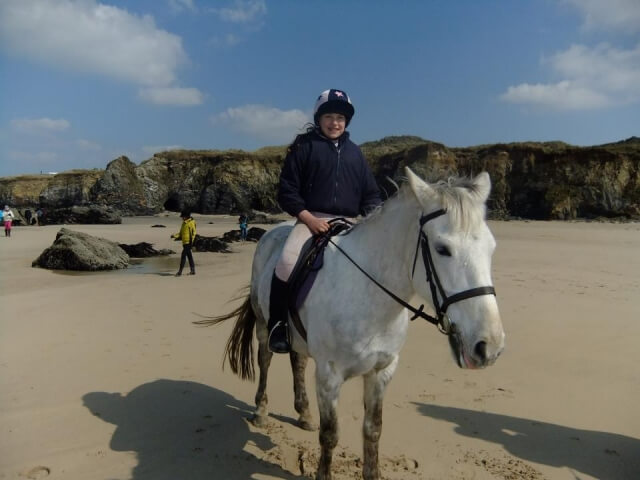 A smartphone displaying the Equestrian Escapes mobile app interface for booking rides.