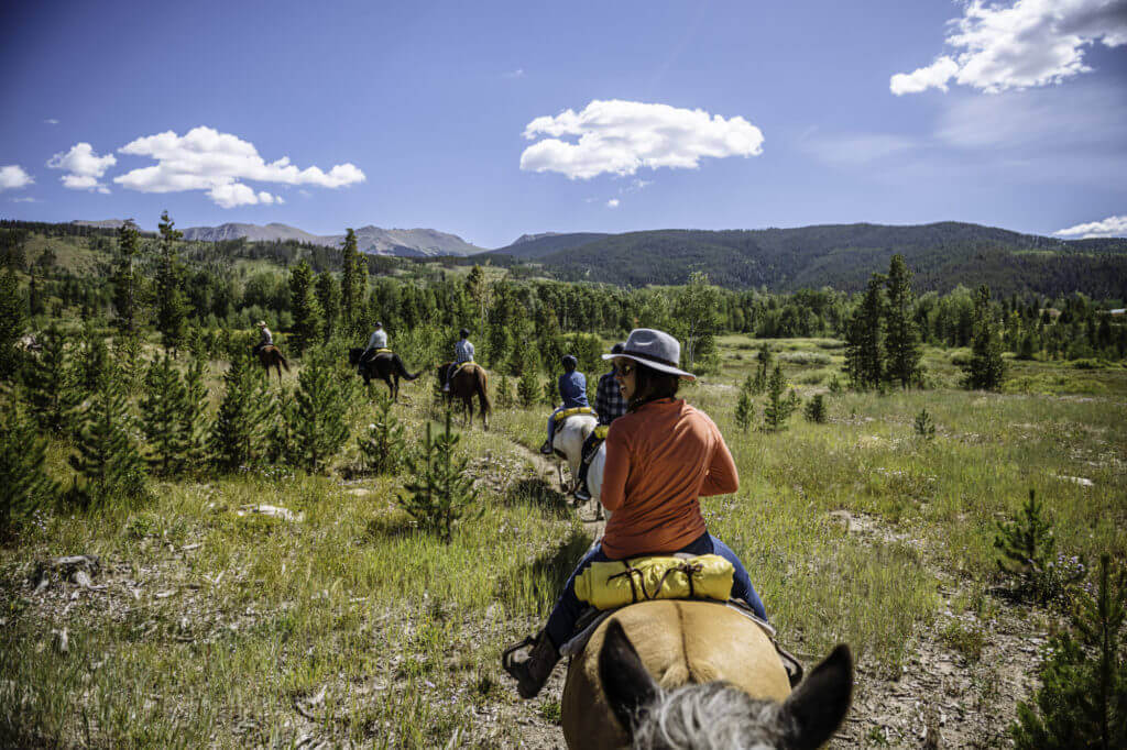 Two riders navigating a rocky, mountainous trail.